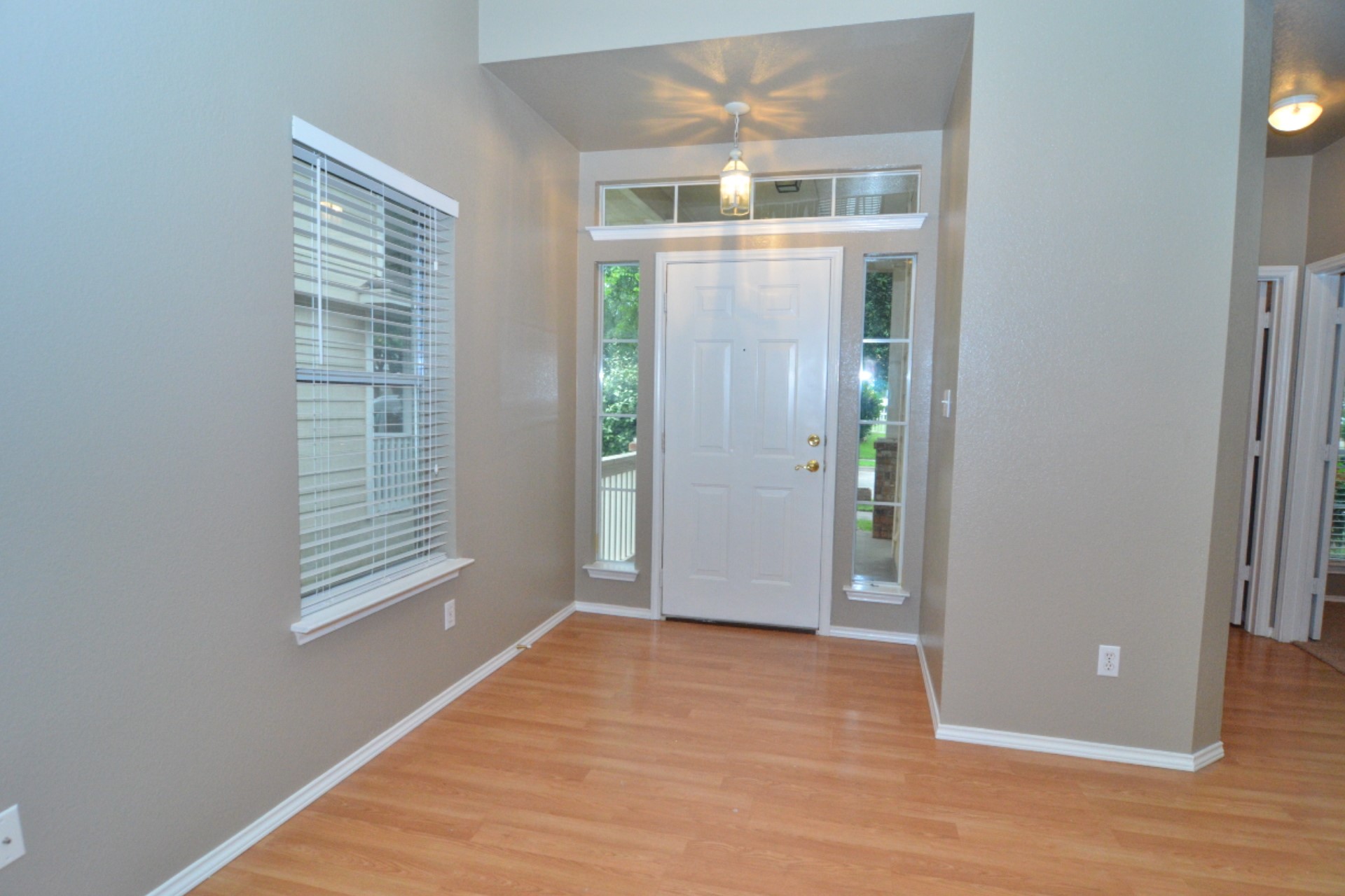 316 Strawn Kyle, TX 78640 - Photo 8 of 34 an empty room with wooden floor and windows