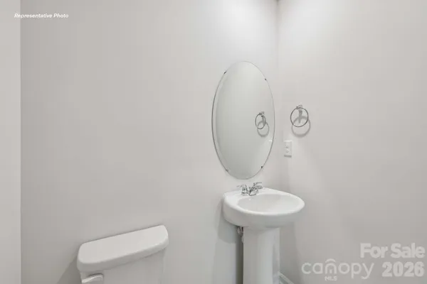 a bathroom with a toilet a sink and a mirror