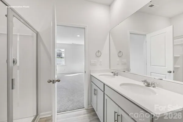 a bathroom with a sink double vanity granite tub and shower