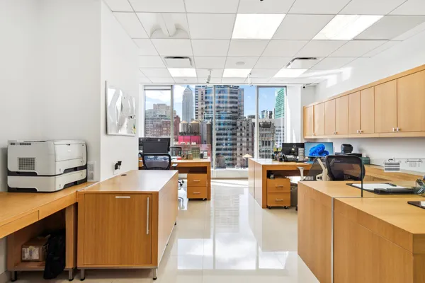 a kitchen with a sink a counter top space a stove and cabinets