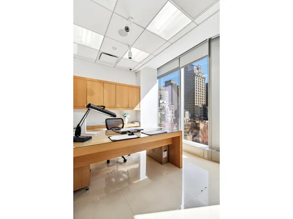 a work room with furniture and wooden floor