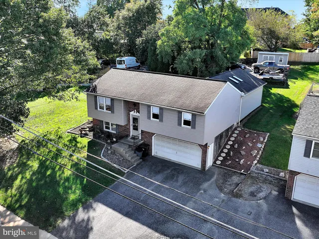 an aerial view of a house with garden space and street view