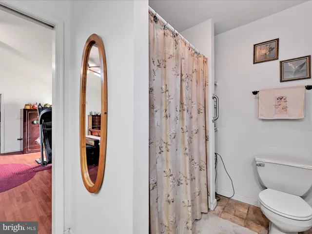 a bathroom with a shower a toilet and a shower