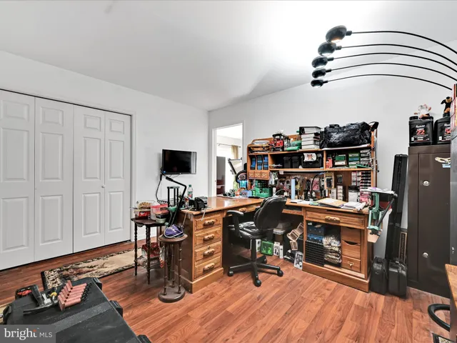 a view of a workspace with furniture and wooden floor