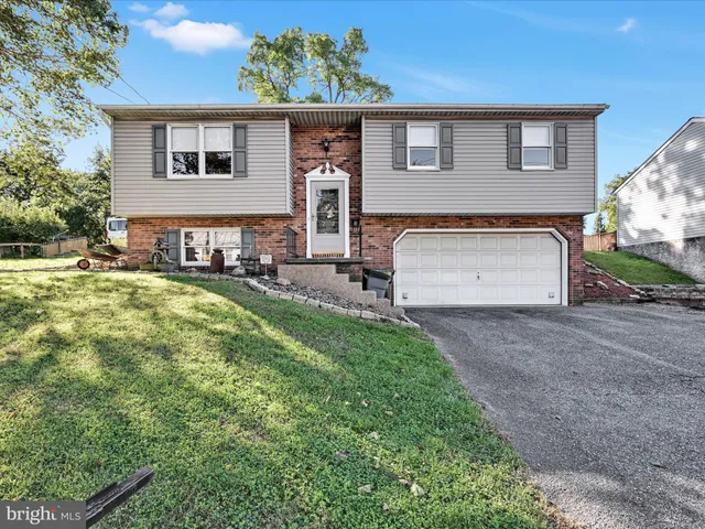 a view of a house with a yard and table and chairs