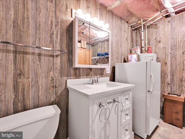 a bathroom with a sink a toilet and a shower curtain