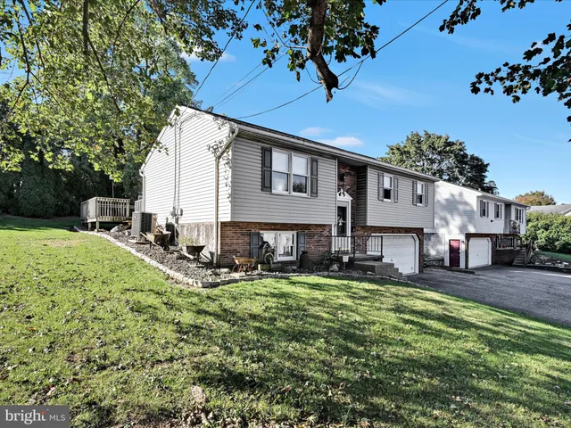 a view of a house with a yard patio and sitting area
