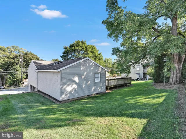 a view of a house with a yard and sitting area