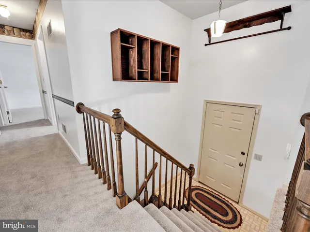 a view of a hallway with staircase