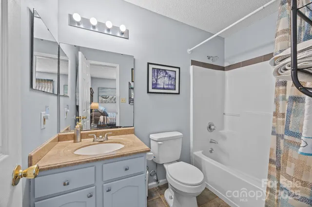 a bathroom with a sink toilet a mirror and shower