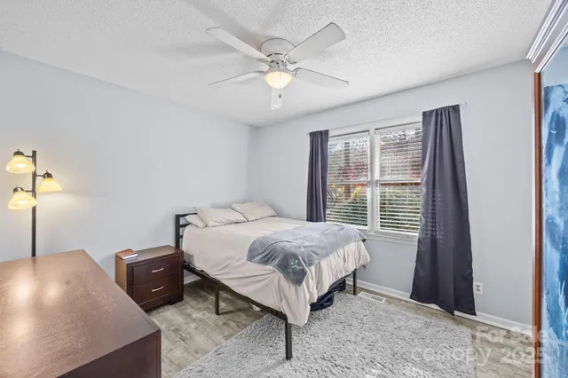 a bed room with a bed and a window