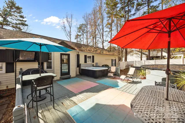 a patio with a table and chairs under an umbrella