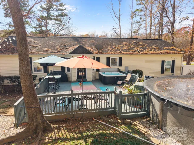 an aerial view of a house with backyard space and swimming pool