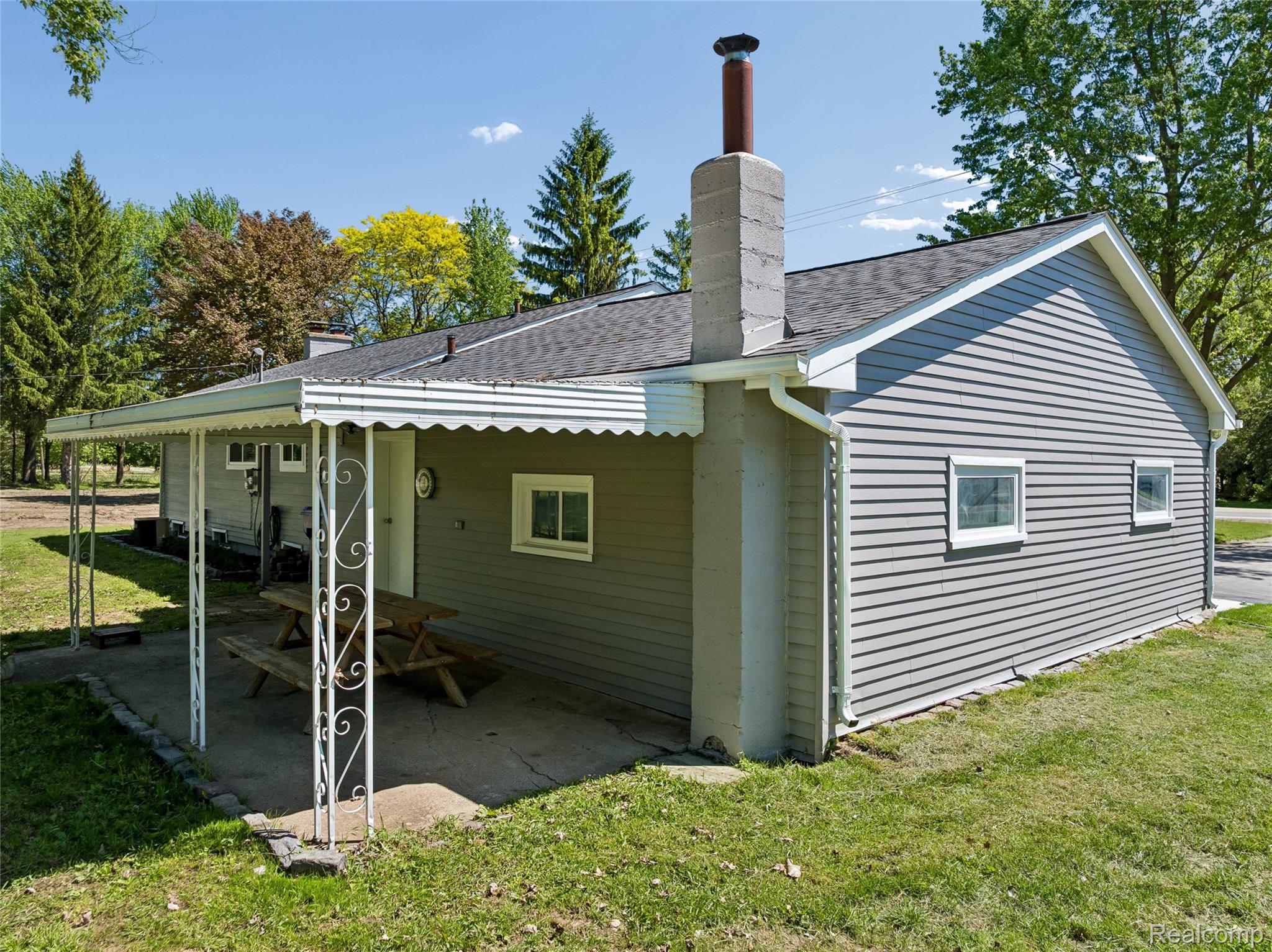6333 North Beck Road Canton, MI 48187 - Photo 5 of 26 Rear view of property with roof with shingles, a lawn, and a chimney