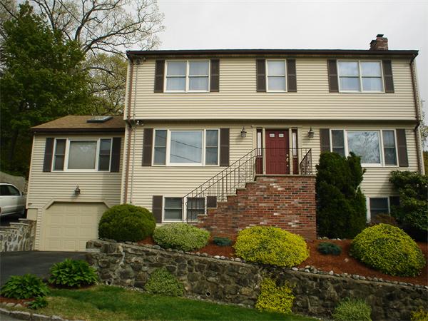 7 Lansdowne Road Arlington, MA 02474 - Photo 1 of 24 a front view of a house with a yard