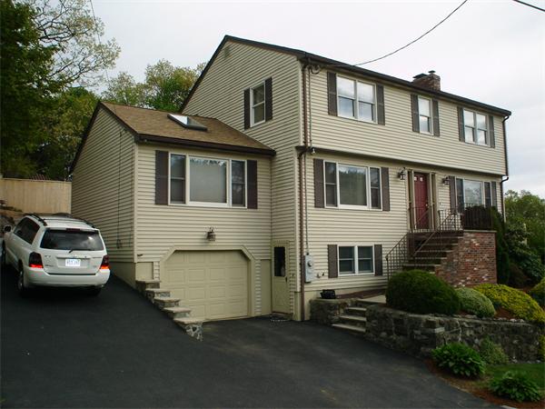 7 Lansdowne Road Arlington, MA 02474 - Photo 2 of 24 a car parked in front of a house