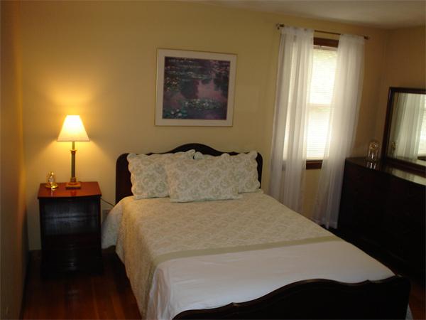 7 Lansdowne Road Arlington, MA 02474 - Photo 21 of 24 a bedroom with a bed and a flat tv screen on dresser
