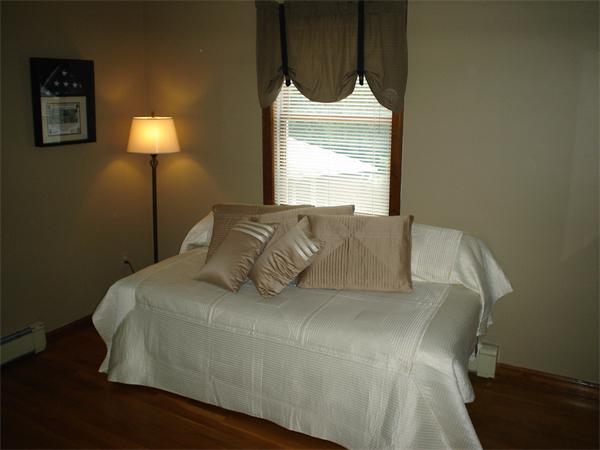 7 Lansdowne Road Arlington, MA 02474 - Photo 24 of 24 a large bed sitting in a bedroom next to a window