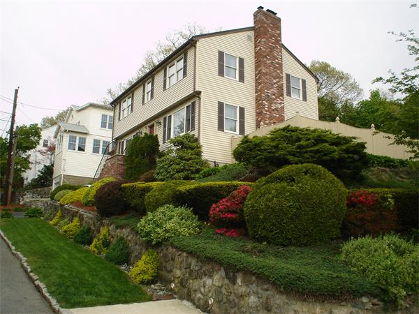 7 Lansdowne Road Arlington, MA 02474 - Photo 3 of 24 a front view of a house with a yard and outdoor seating
