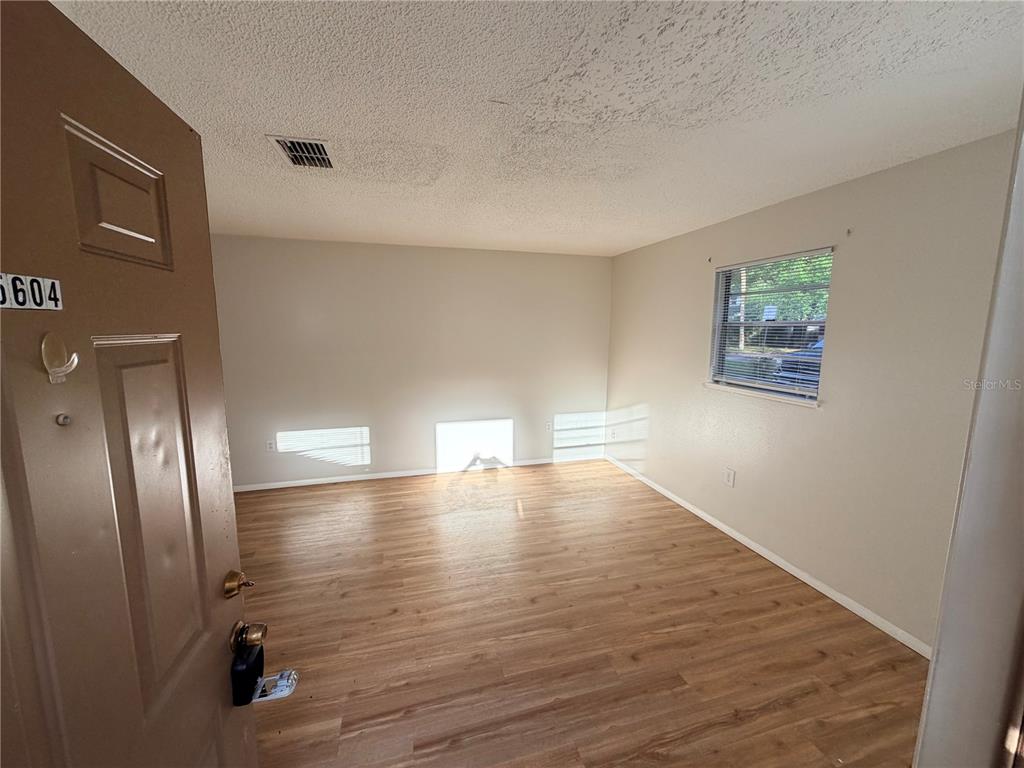 5604 Montana Avenue New Port Richey, FL 34652 - Photo 2 of 10 a view of empty room with wooden floor