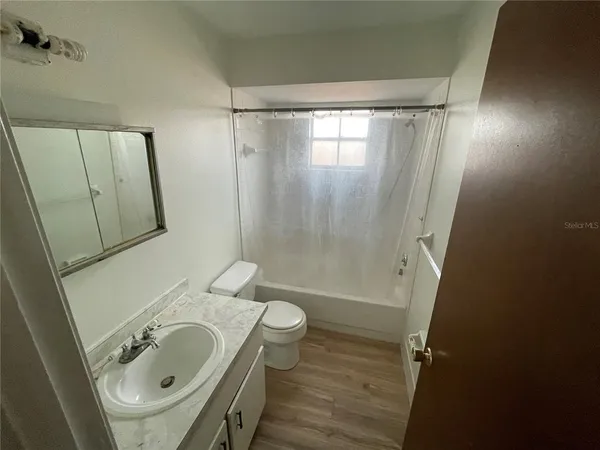 a bathroom with a sink a toilet and a tub