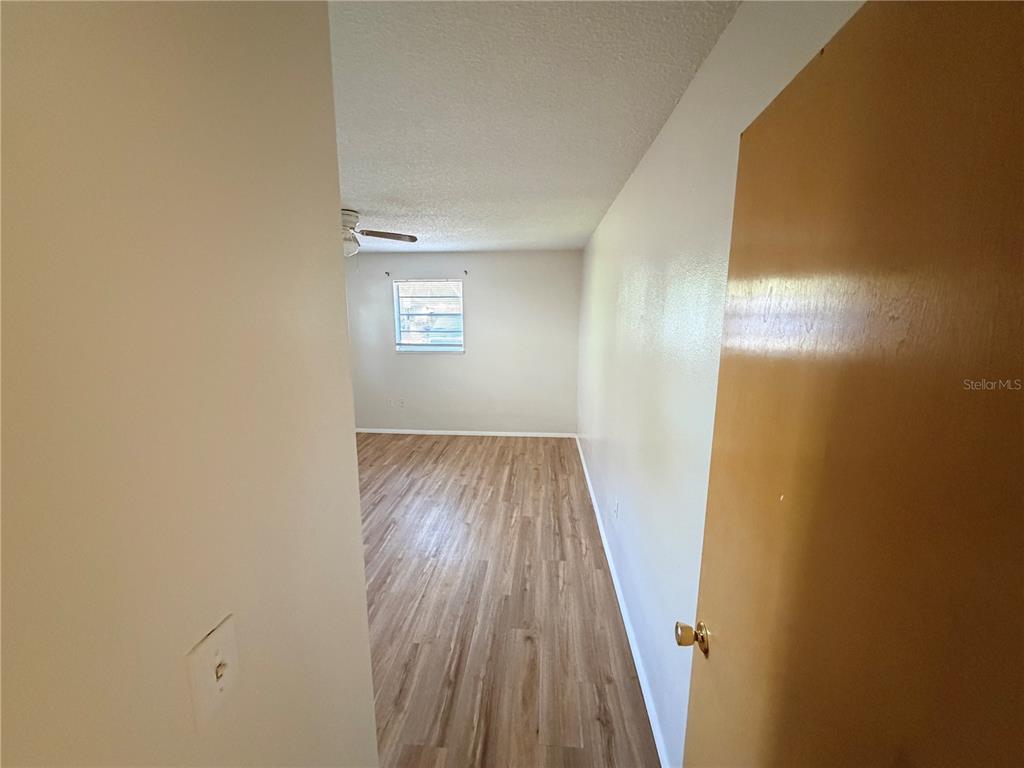 5604 Montana Avenue New Port Richey, FL 34652 - Photo 8 of 10 a view of a hallway with wooden floor