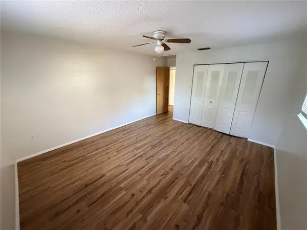 a view of empty room with wooden floor