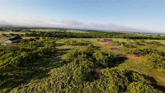 an aerial view of a houses with a yard