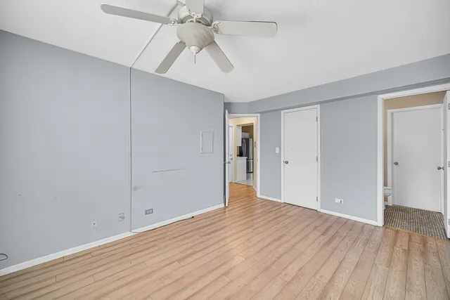 a view of an empty room with wooden floor