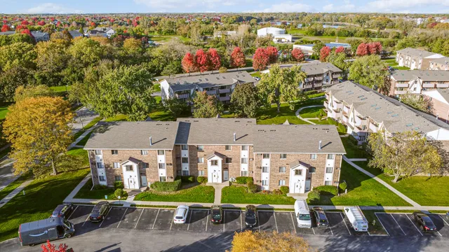 an aerial view of residential houses with outdoor space and street view