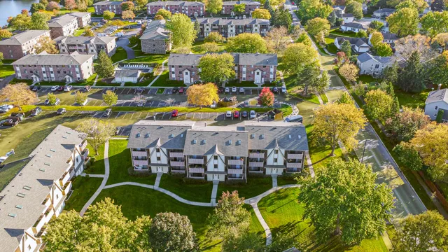 an aerial view of a swimming pool with outdoor seating