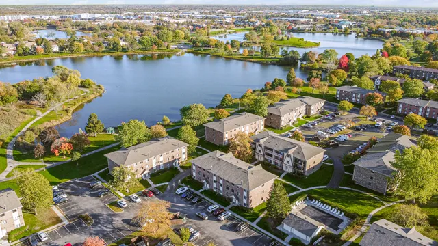 an aerial view of lake and residential houses with outdoor space