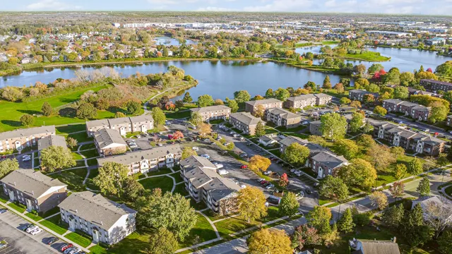 an aerial view of lake and residential houses with outdoor space and ocean view