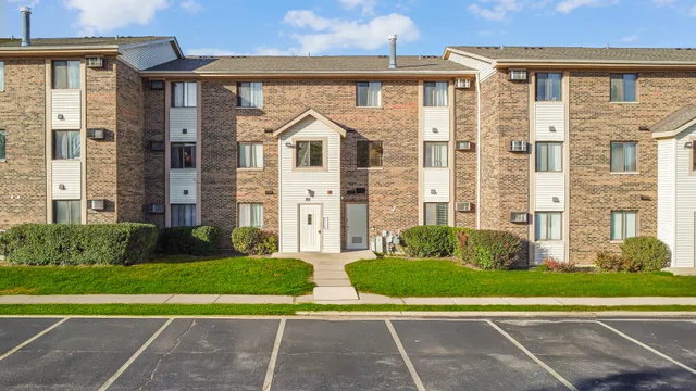 a view of a brick building next to a yard