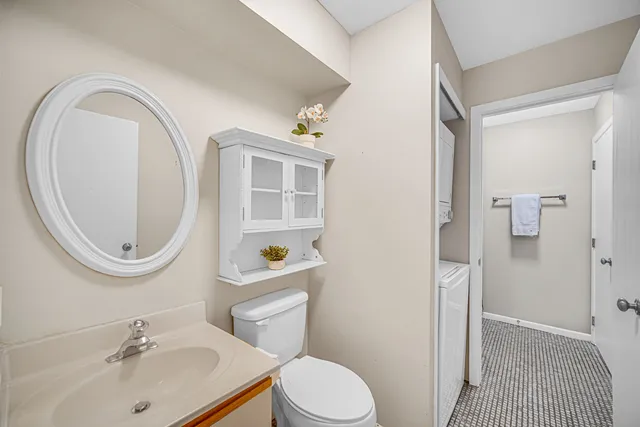 a bathroom with a sink a toilet and a mirror