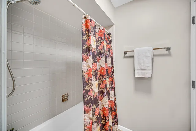 a bathroom with a shower and a curtain