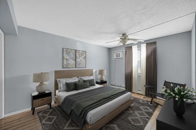 a bedroom with bed and a chandelier