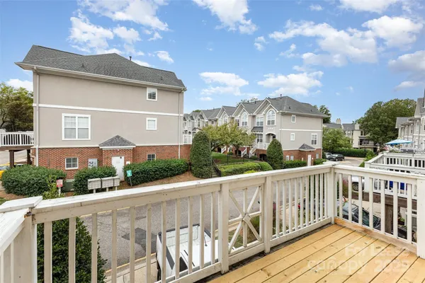 a view of a house with wooden deck