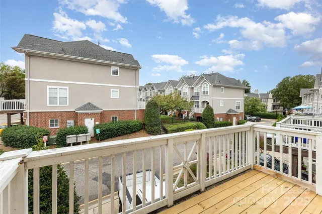a view of a house with wooden deck