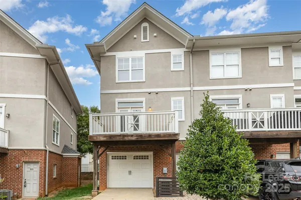 a view of a patio with couches table and chairs and potted plants