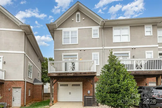 a view of a patio with couches table and chairs and potted plants