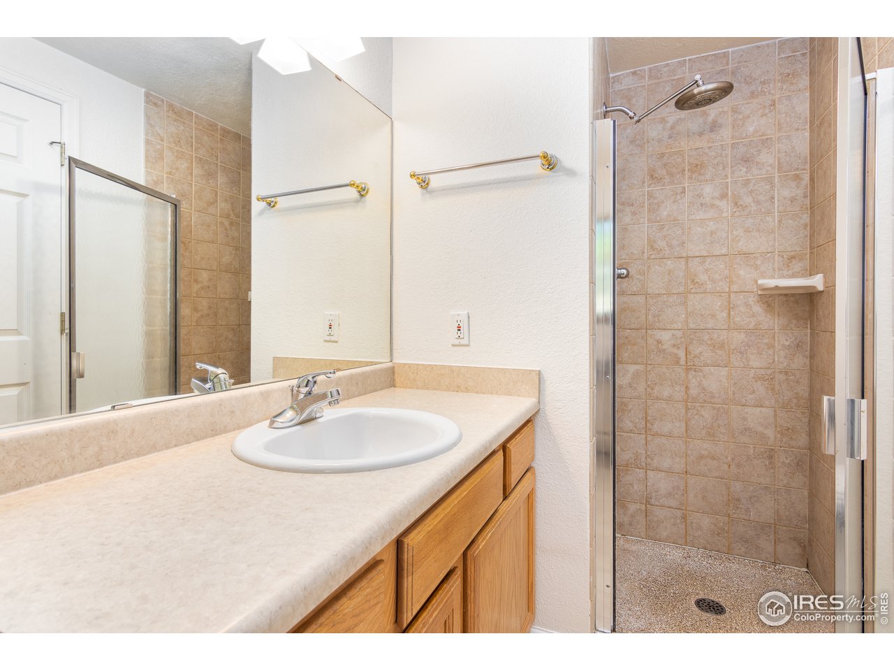 4579 Northeast County Line Road Erie, CO 80516 - Photo 12 of 38 a bathroom with a sink and a mirror