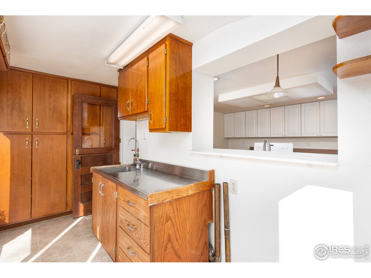 4579 Northeast County Line Road Erie, CO 80516 - Photo 13 of 38 a kitchen with a sink a counter top space and cabinets