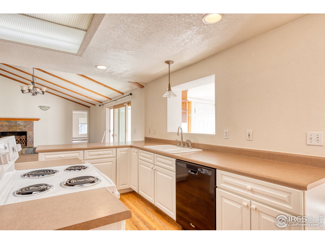 4579 Northeast County Line Road Erie, CO 80516 - Photo 14 of 38 a kitchen with a sink stove and cabinets