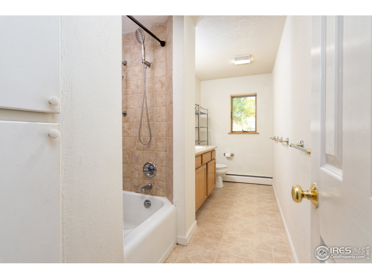 4579 Northeast County Line Road Erie, CO 80516 - Photo 16 of 38 a bathroom with a tub a sink and a shower