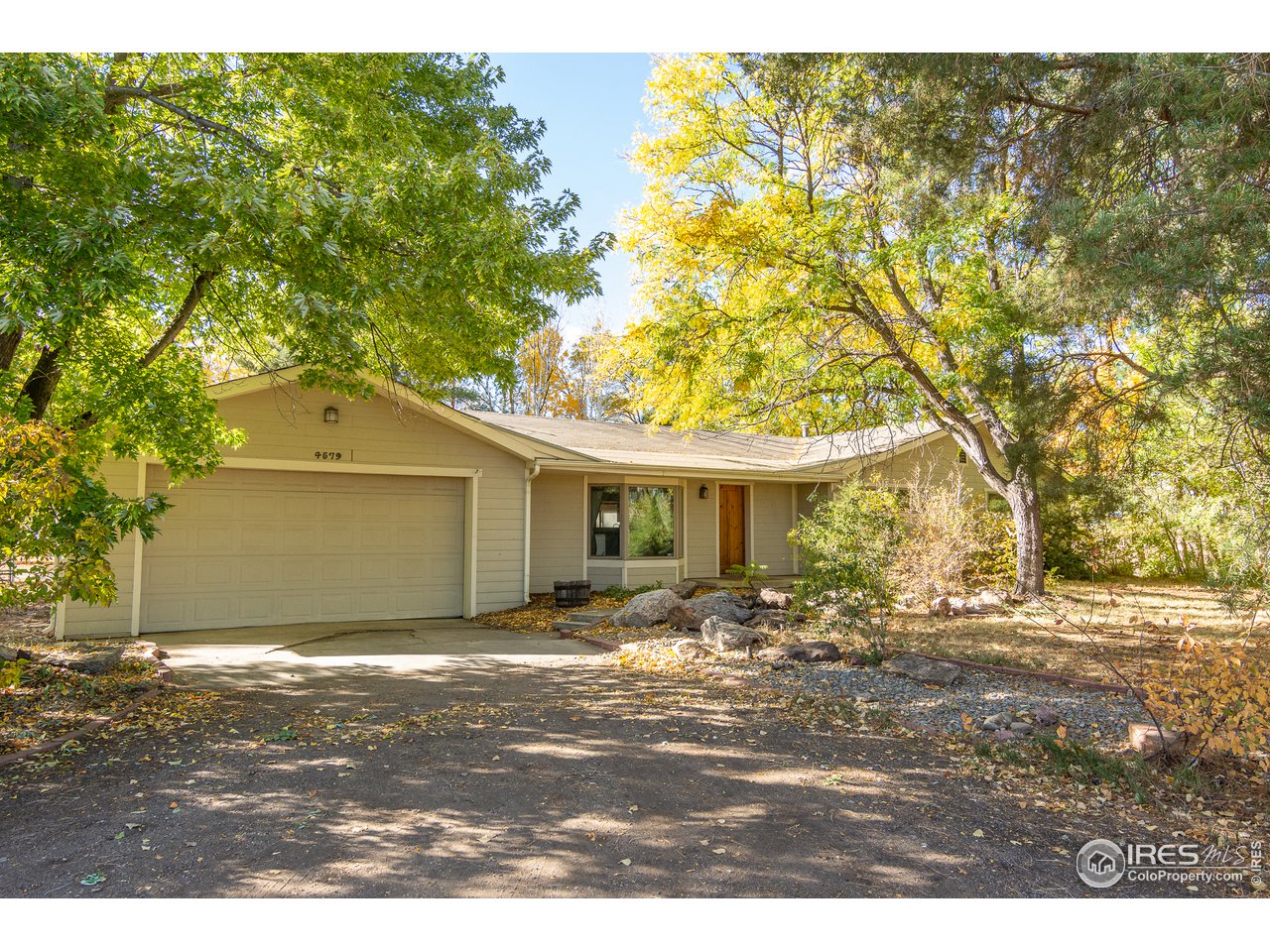 4579 Northeast County Line Road Erie, CO 80516 - Photo 2 of 38 a view of a yard in front of a house with large trees