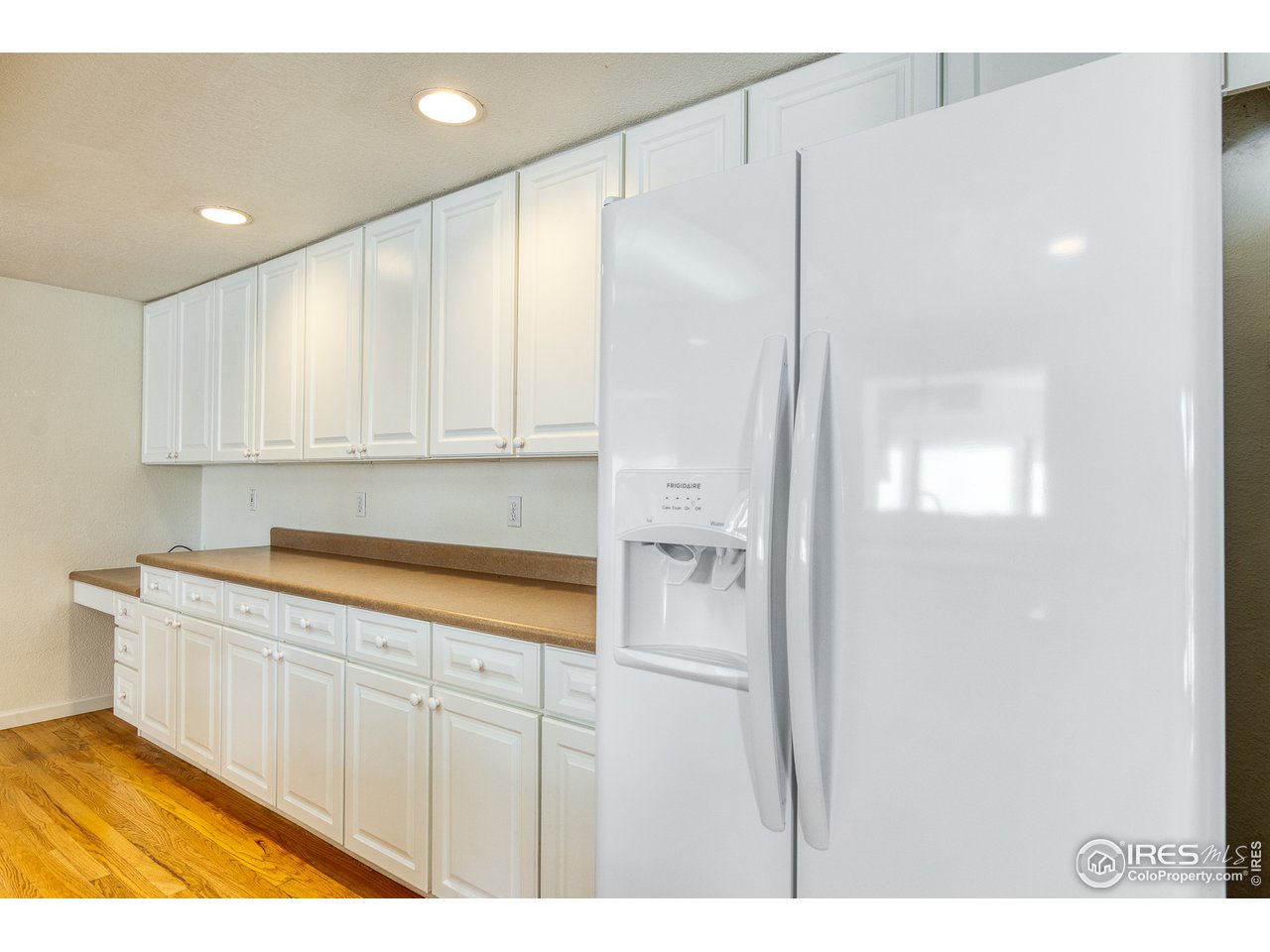 4579 Northeast County Line Road Erie, CO 80516 - Photo 6 of 38 a kitchen with white cabinets and sink