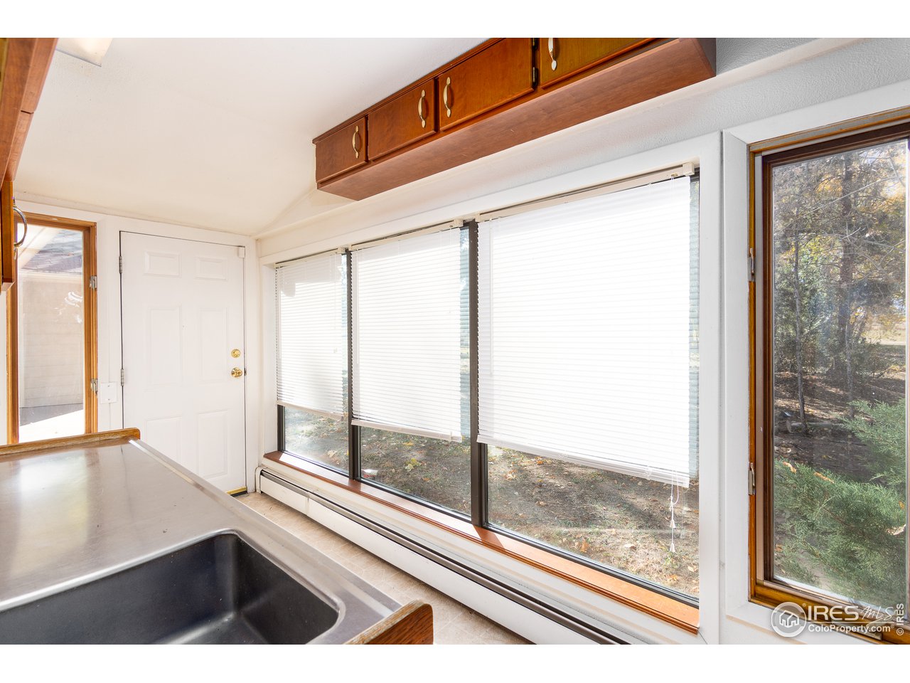4579 Northeast County Line Road Erie, CO 80516 - Photo 7 of 38 a view of an empty room with wooden floor and a window