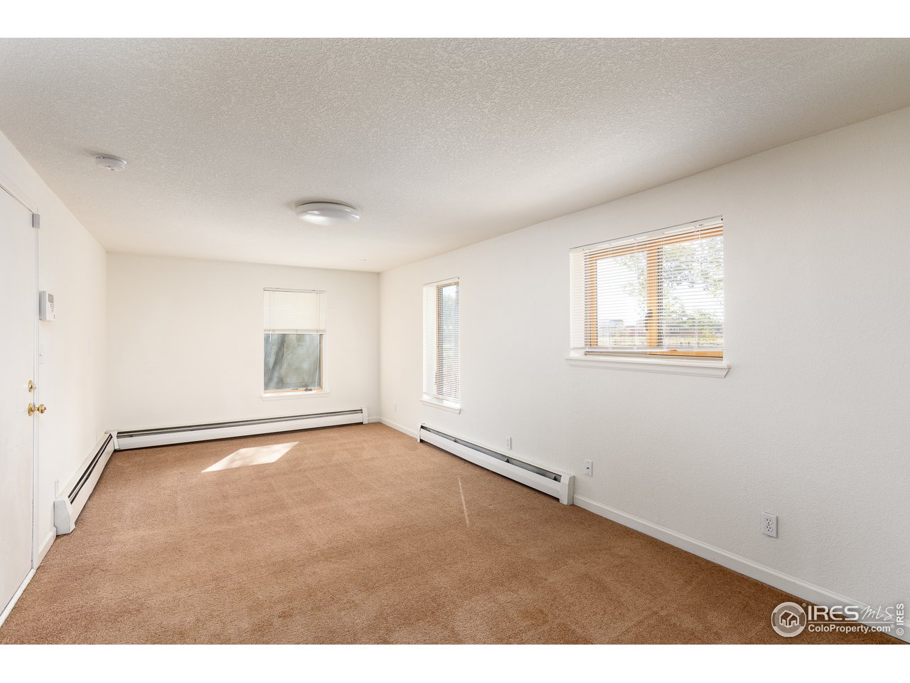 4579 Northeast County Line Road Erie, CO 80516 - Photo 8 of 38 an empty room with windows