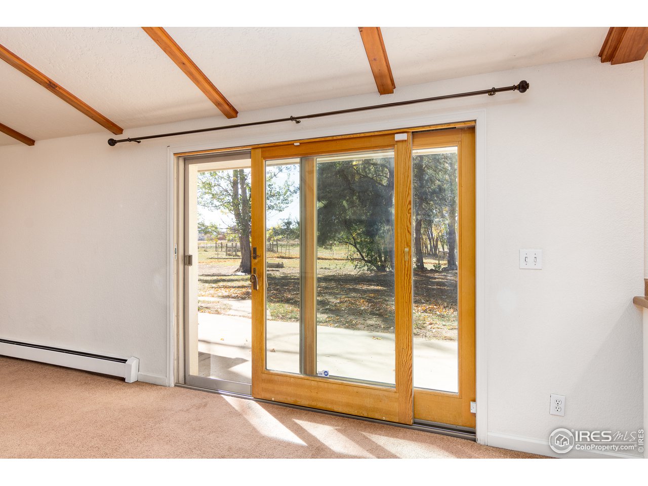 4579 Northeast County Line Road Erie, CO 80516 - Photo 9 of 38 a view of a room with wooden floor and windows